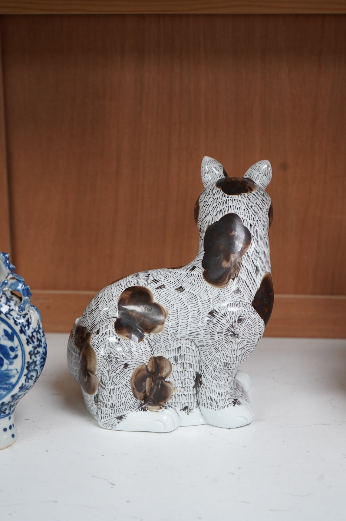 A 19th century Chinese blue and white small moon flask together with a later jar and a Portugese porcelain copy of a Chinese export cat, largest 19cm high